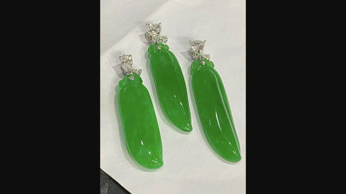 Carved green jadeite pendant trio