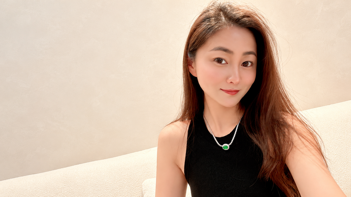 Mulan Jade owner wearing a green jade pendant